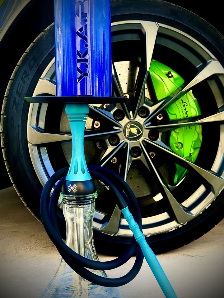 Blue shisha in front of a sports car wheel