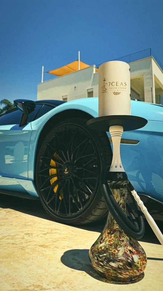 7CEAS branded shisha beside a blue supercar